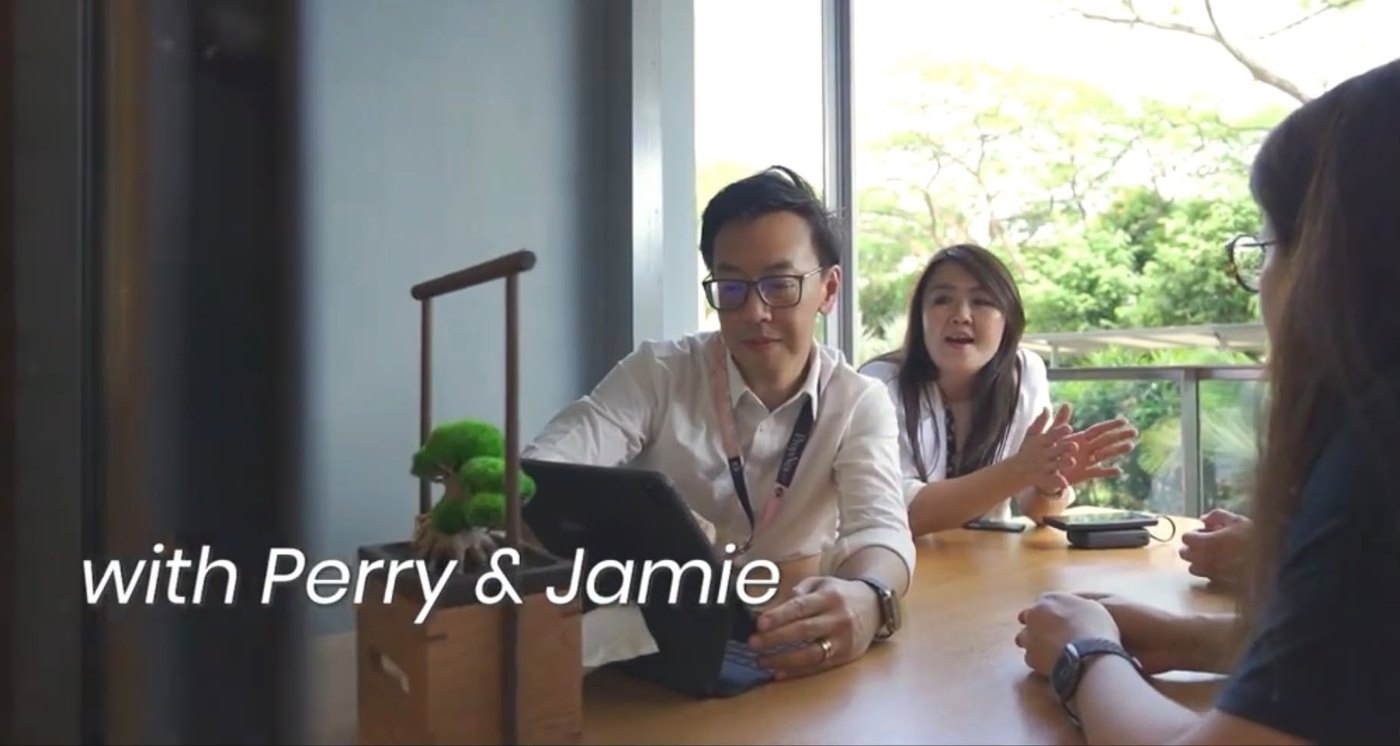 Perry Siow and Jamie Yoeng reviewing a property with a client