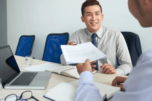 Client handing documents to a bank officer